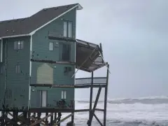 Dozens rescued as remnants of typhoon hits Alaska while nor’easter brings flooding to East Coast